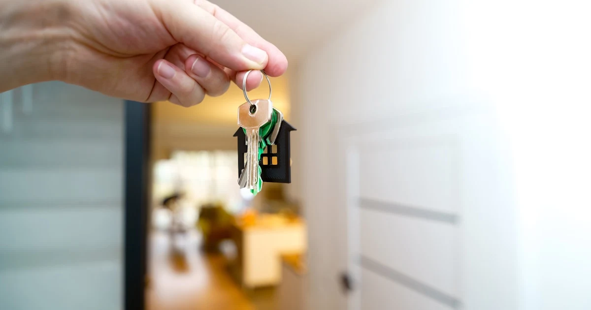 Real estate agent handing over property keys